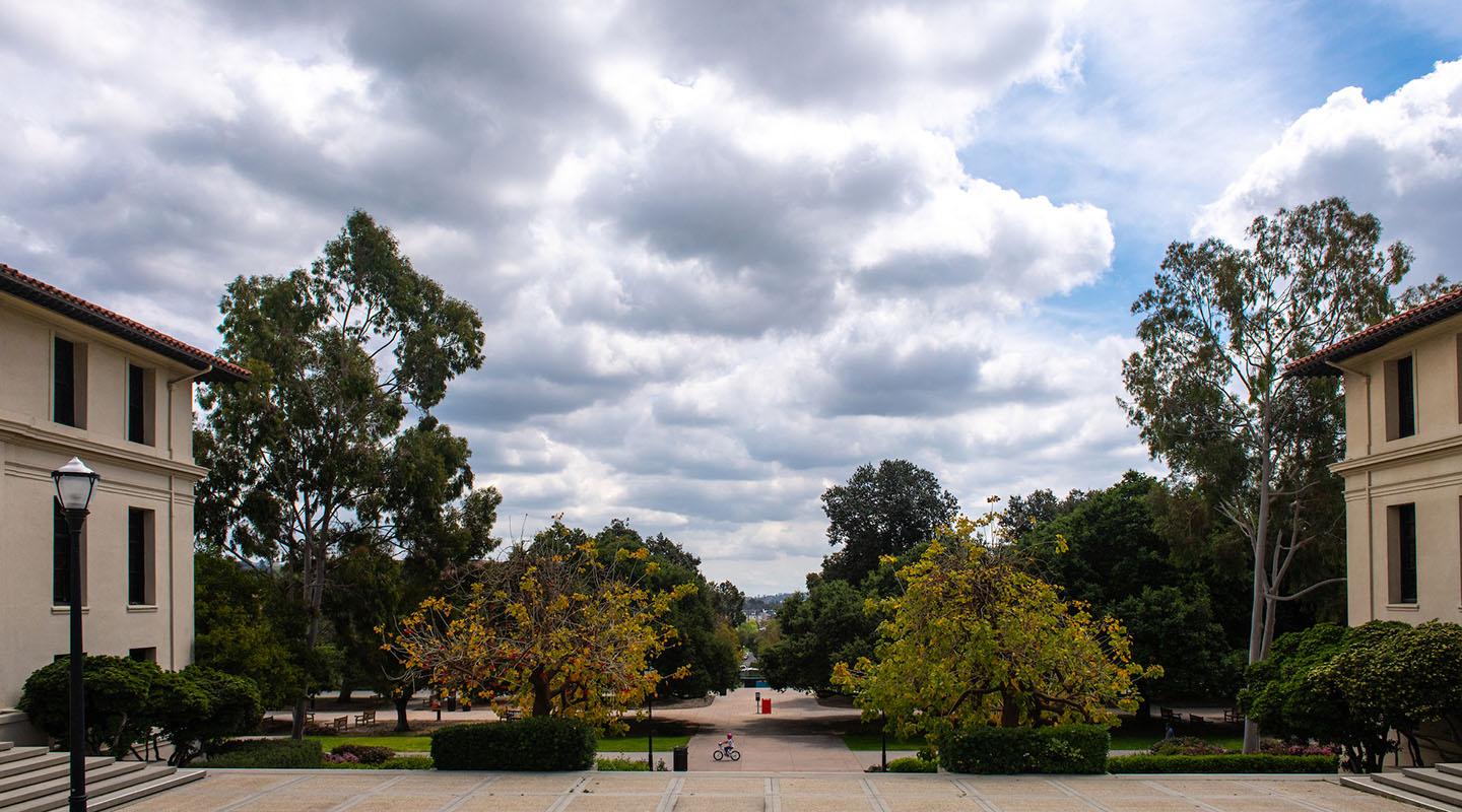 a view of campus buildings and the open cloudy sky