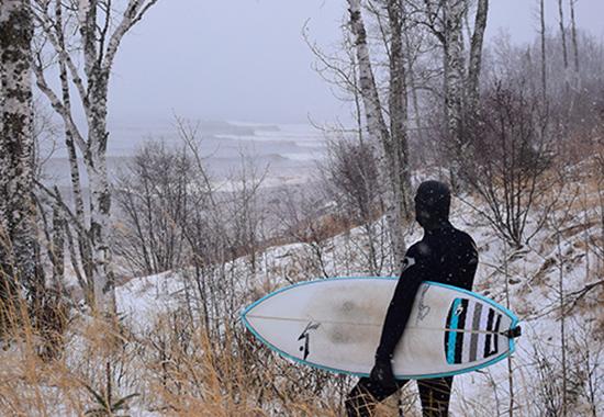 Keala Ede ’00 prepares to surf on Lake Superior in Minnesota.