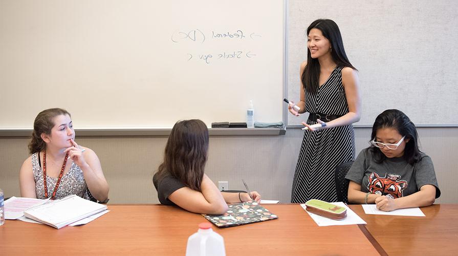 教授essor 简在香港 teaches three students in a classroom