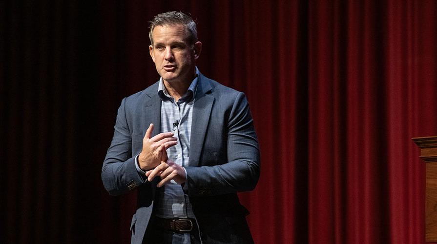 Republican Adam Kinzinger on a stage in Thorne Hall