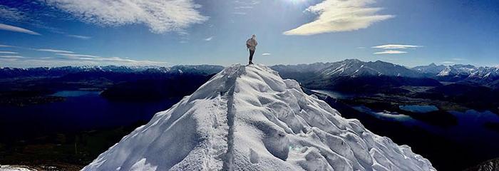 Oxy student Annika Smith standing at the summit of Roy's Pea