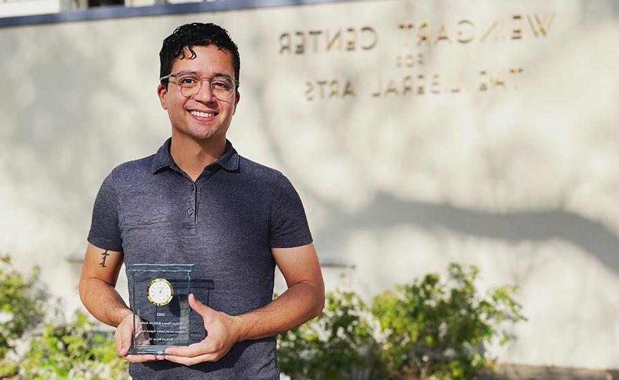 Richard Reyes '12 holds his CTSJ alumni social justice award