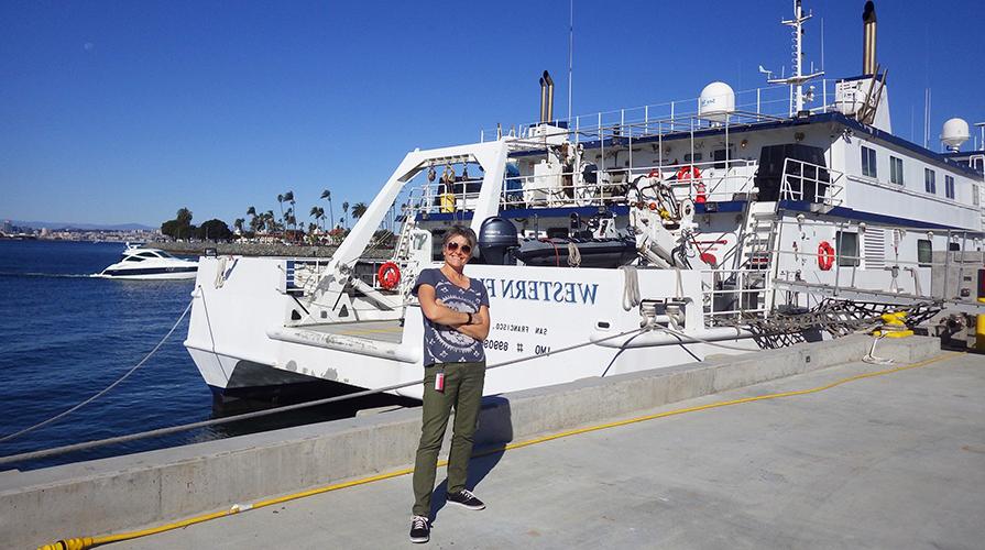 Professor Shana Goffredi in front of a research ship