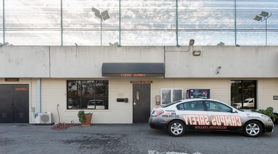 A shot of the campus safety building and a campus safety car