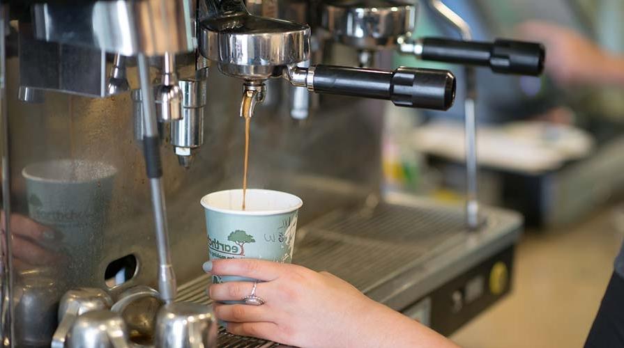 A barista pours an espresso drink at the student-run Green Bean