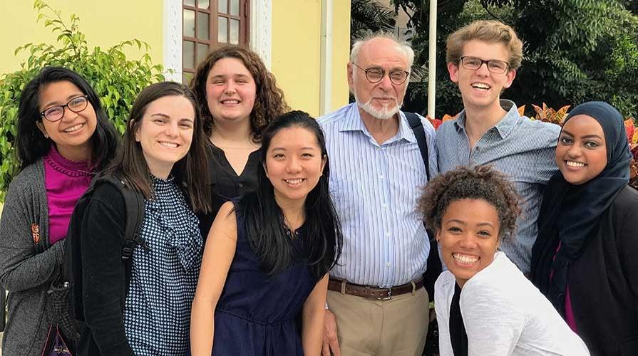 Students gather with a professor