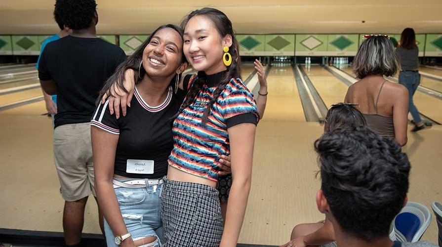 Two happy students pose together