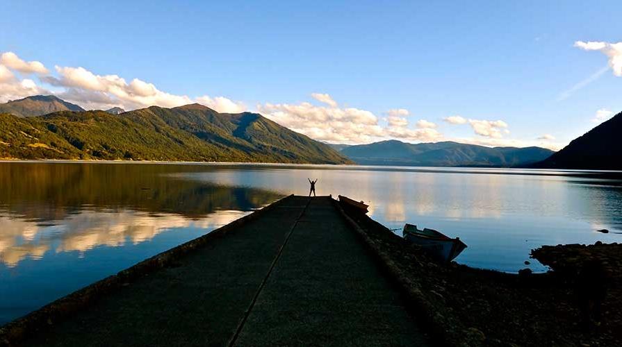 A student in front of a beautiful lake