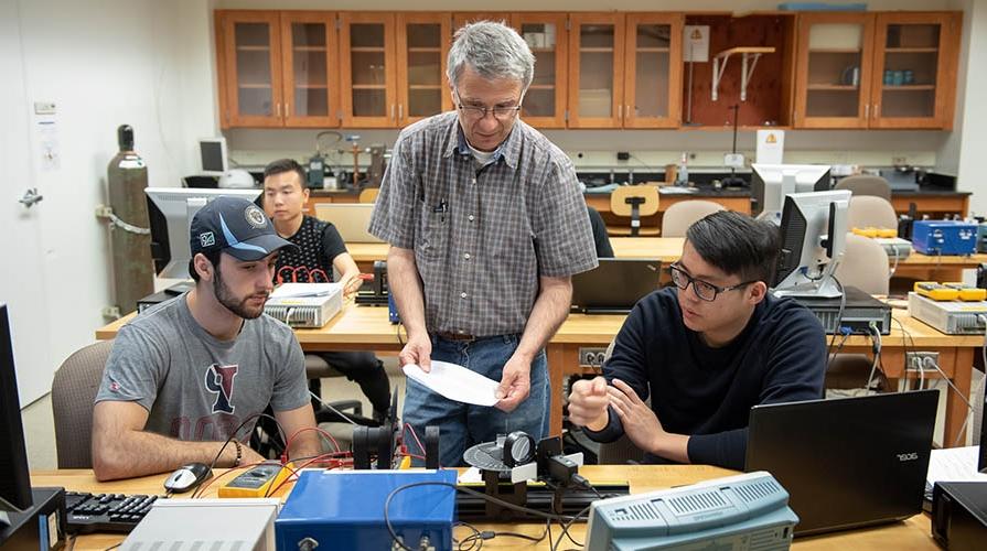 Students and professor work in the lab