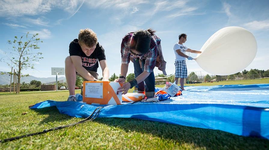 Physics students working on a project outdoors