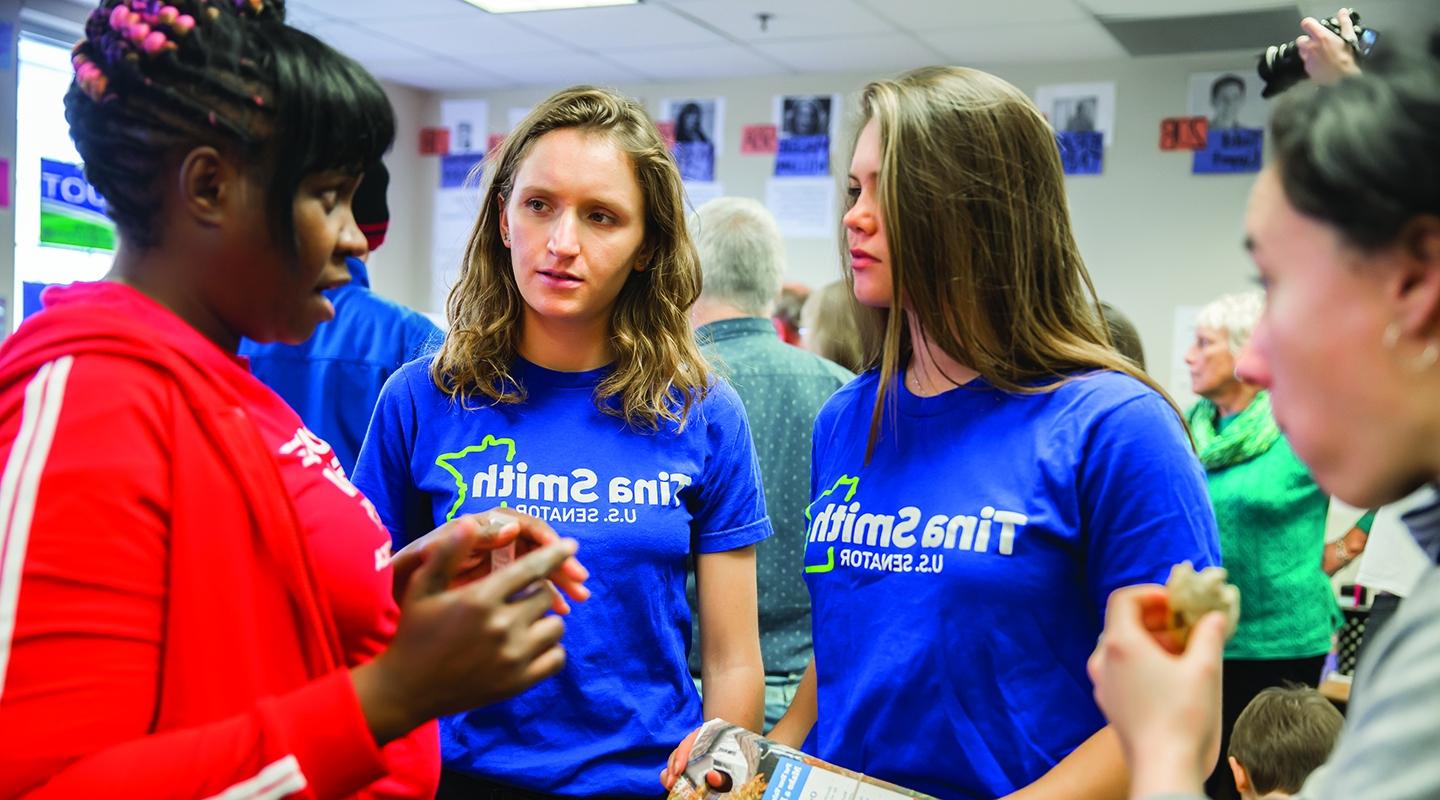 Two Occidental College Campaign Semester participants talking to another woman