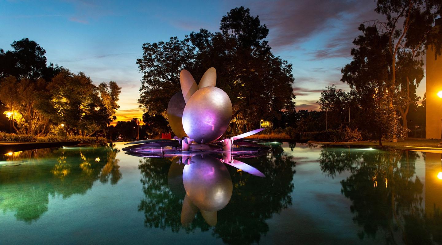 The renovated Gilman Fountain illuminated by a rainbow of colors at dusk