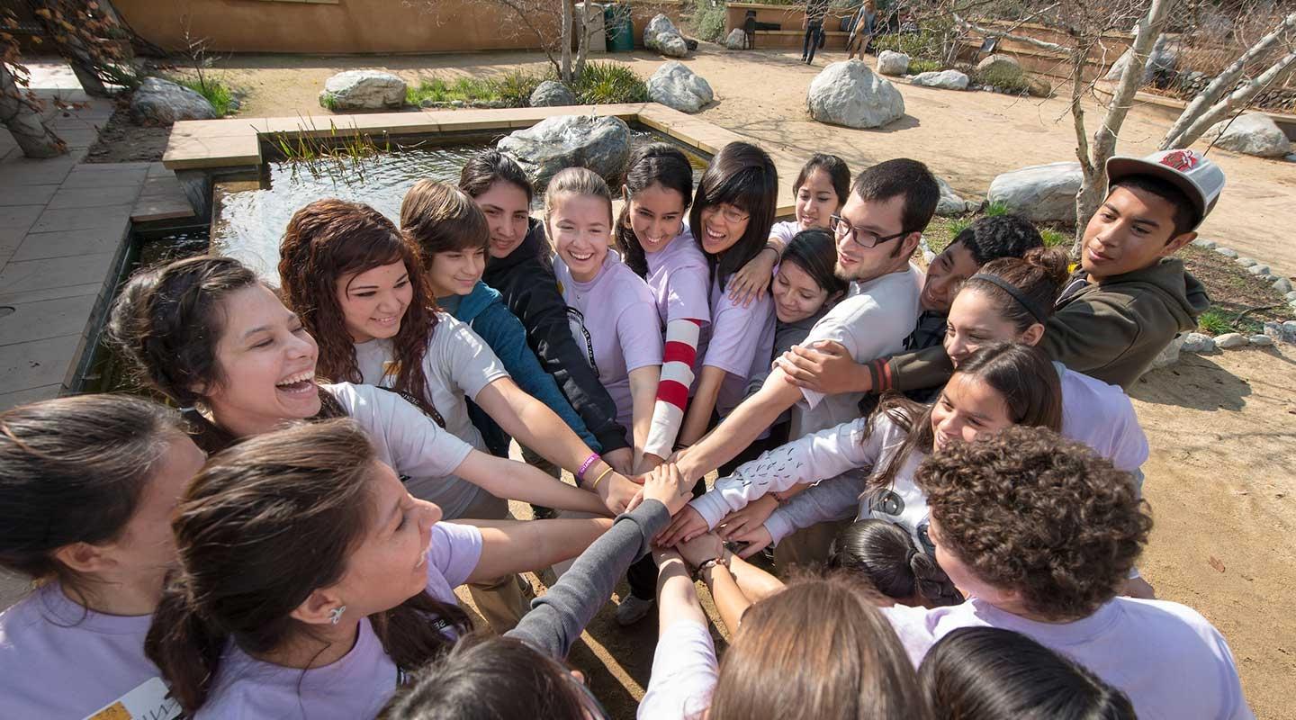 Oxy students in a huddle amid community service work