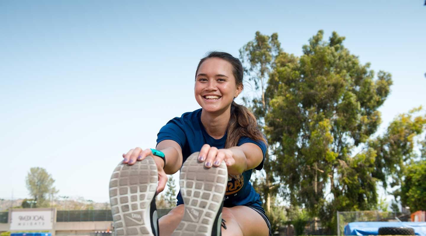 Oxy student stretching on the lawn