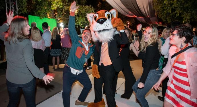 Happy Oxy alumni standing with Oswald at the alumni reunion event on campus.