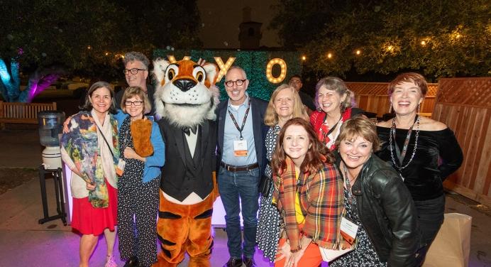 A group of Occidental alumni pose with Oswald at Alumni Reunion