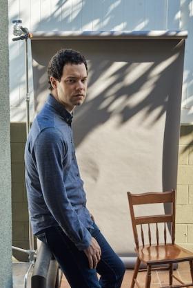 Instructor Max Foreman standing next to a chair