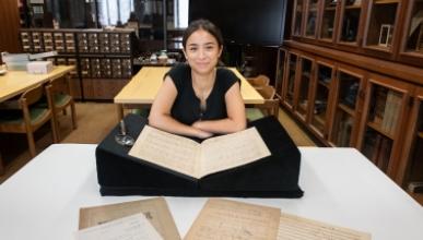 Francesca Rodoni '24 examining a musical manuscript of Franz Liszt