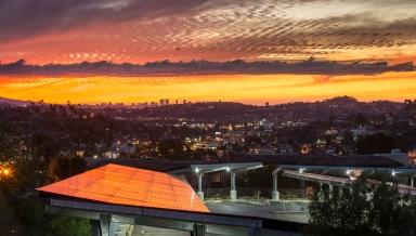 西方's solar array reflects a colorful sunset in 2014. 