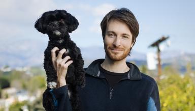 Zak Stoltz '10 with his dog, Boba, at his home in Mount Washington.