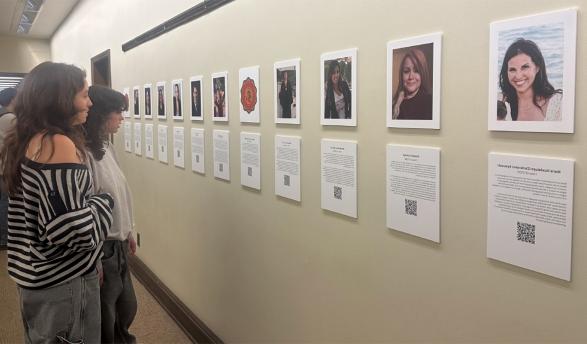 Spectators view the OCLAA oral history gallery in the Academic Commons in February 2024.