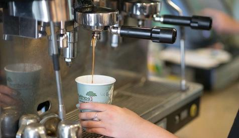 A barista pours an espresso drink at the student-run Green Bean