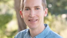 Dr. Brandon Taylor in front of a tree