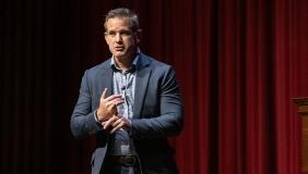 Republican Adam Kinzinger on a stage in Thorne Hall