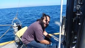 Babak Hassanzadeh doing research with the ocean behind him