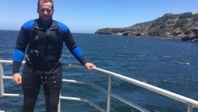 Ryan Freedman on boat with diving gear