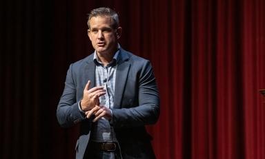 Republican Adam Kinzinger on a stage in Thorne Hall