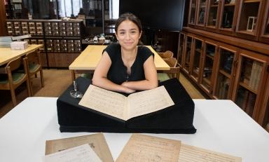 Francesca Rodoni '24 examining a musical manuscript of Franz Liszt