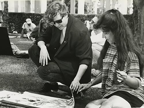 Besemer reviews a student’s work during an art class on the front lawn of Weingart in April 1992. 